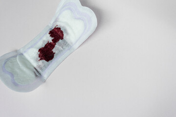 Menstrual blood on a sanitary pad. Flat lay. Copy space.