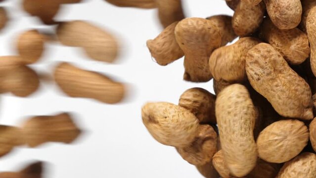 peanuts fall in slow motion and cover the whole screen, vertical video