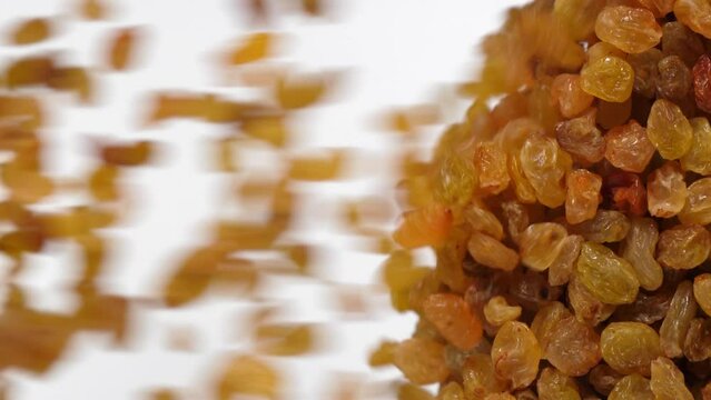 raisins fall in slow motion and cover the whole screen, vertical video