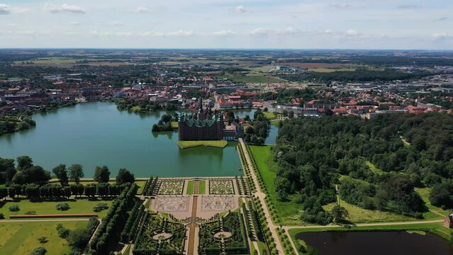Aerial View Over An Opulent Garden And The Frederiksborg Castle In Hillerod Denmark - drone pullback