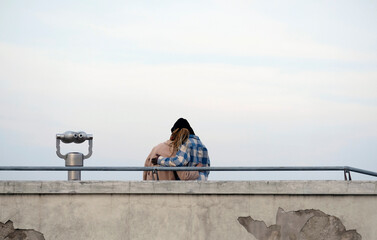 Couple embracing at a viewpoint at Castel Sant Elmo in Naples, Italy