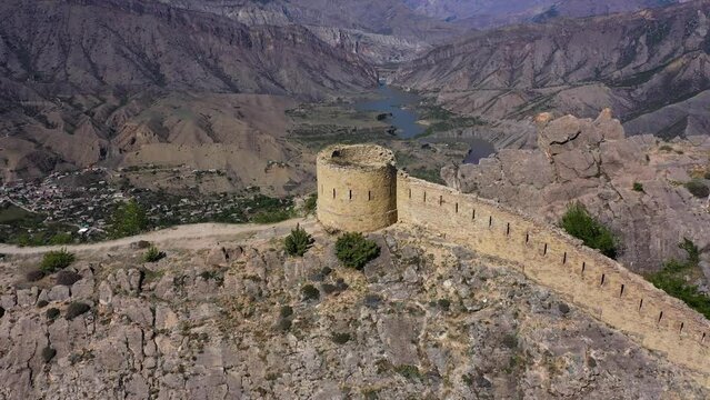 Great wall stone fortress tower Gunib Dagestan. Summer. Aerovideo
