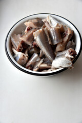 Pieces of raw Whiting fish for frying in a saucepan