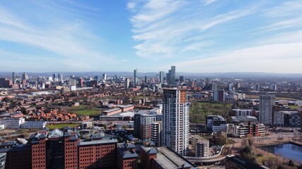 Drone image of Salford Quays with modern buildings and landmarks and views towards Manchester.  - obrazy, fototapety, plakaty