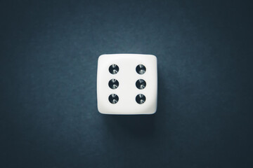 White dice on black table background