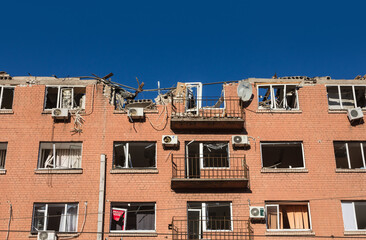 Fototapeta na wymiar Residential building damaged by russian rocket attack