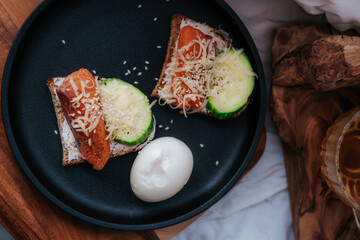 Open sandwich or toast. Grain bread with salmon, avocado, cucumber and cheese. Healthy snack concept. Place for text.