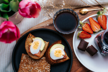 Homemade Easter breakfast top view. Free space for text. Toast with eggs and black coffee.
