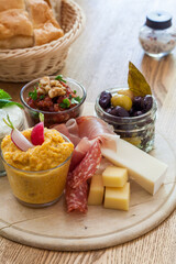 Platter of cheese, vegetables, sauces and salads, served with bread