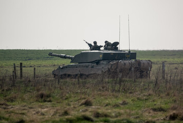 British army FV4034 Challenger 2 main battle tank with Commander and gunner directing, in action on...