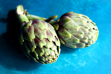 Still life with fresh artichoke flowers. Close up photo of beautiful natural pattern. Eating healthy concept. 