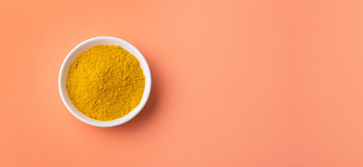 Organic curry yellow powder in the ceramic bowl - Healthy food