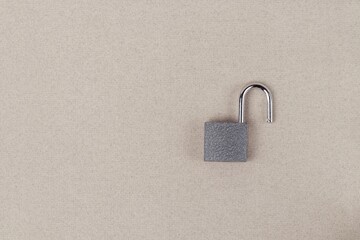 Padlock in the open on a gray background close-up. Security concept