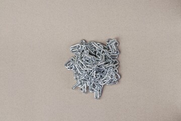 Pile of metal chains on a gray background. Close-up