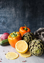 Still life with fresh organic artichokes on a table. Close up photo of seasonal vegetables. Eating fresh concept. 