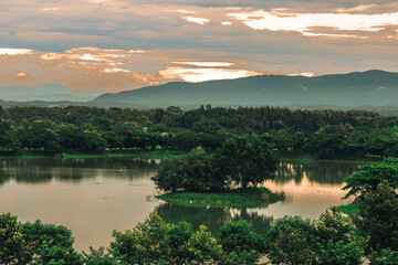 Natural blurred background of fog scattered among trees in the morning, with soft sunlight from the sun, seasonal beauty.
