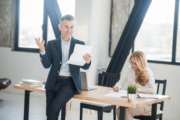 A man in a suit with documents in hands