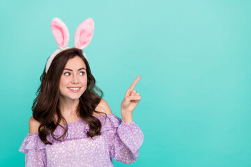 Portrait of attractive girly cheerful girl wearing ears demonstrating copy space ad isolated over...