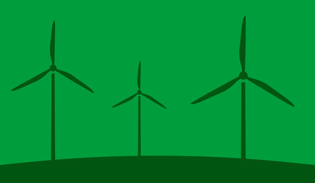 Wind turbines / windmills on a green field next to each other.
