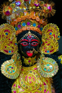 Kolkata, West Bengal, India - 7th October 2018: Painted idol of Goddess Kali with black face and red tongue. Goddess of Time, Creation, Destruction and Power. Beautifully decorated with shining crown.