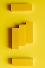 top view of bright tetragonal blocks on yellow background.
