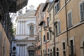 Fototapeta na wymiar Rome Via dei Farnesi Street View with White Church and Traditional House Facades, Italy