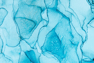Fluid ink watercolor blue paint colors background. Abstract blue texture background. Mixing acrylic paints. Alcohol Ink Pattern.