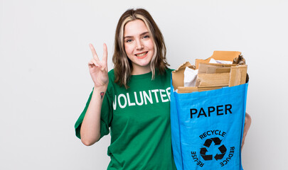 pretty caucasian woman smiling and looking happy, gesturing victory or peace. ecology concept
