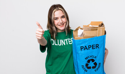 pretty caucasian woman feeling proud,smiling positively with thumbs up. ecology concept