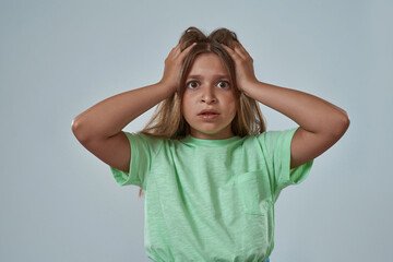 Cropped of scared little girl touching her head