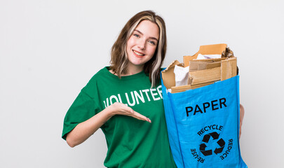 pretty caucasian woman smiling cheerfully, feeling happy and showing a concept. ecology concept