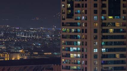 Fototapeta na wymiar Aerial view of apartment houses and villas in Dubai city night timelapse, United Arab Emirates