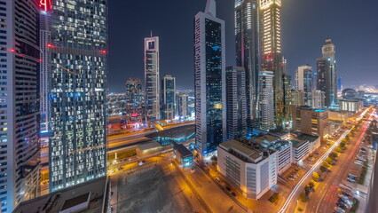 Aerial view of Dubai International Financial District with many skyscrapers night timelapse.