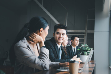 young businessman happy expression and smiling cheerfully in a good mood Sitting and discussing with a team