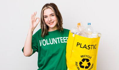 pretty caucasian woman feeling happy, showing approval with okay gesture. ecology concept