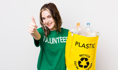 pretty caucasian woman feeling proud,smiling positively with thumbs up. ecology concept
