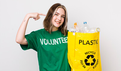 pretty caucasian woman smiling confidently pointing to own broad smile. ecology concept