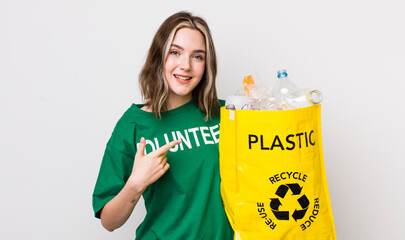 pretty caucasian woman looking excited and surprised pointing to the side. ecology concept
