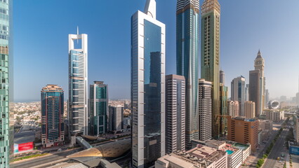 Fototapeta na wymiar Aerial view of Dubai International Financial District with many skyscrapers all day timelapse.