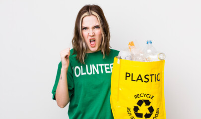 pretty caucasian woman shouting aggressively with an angry expression. ecology concept