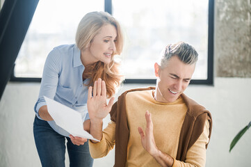 A man and a woman in the office talking and discussing a project