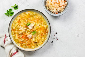 Instant pot sauerkraut soup in plate. Top view, copy space, flat lay.
