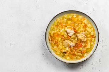 Crock pot sauerkraut soup in plate. Top view, copy space, flat lay.
