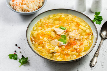 Probiotic sour cabbage sauerkraut soup in plate. Top view, copy space, flat lay.