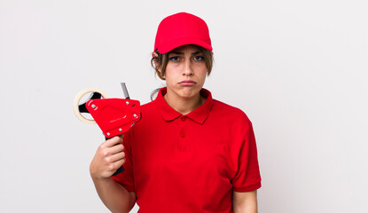 pretty hispanic woman feeling sad and whiney with an unhappy look and crying. packer concept
