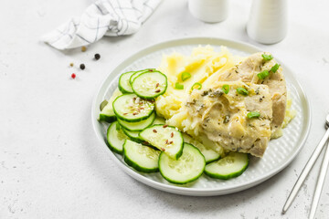 Healthy dietitian mashed potatoes, cucumber salad, chicken. Copy space.