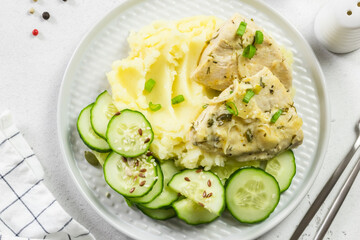 Mashed potatoes, cucumber salad, stewed chicken. Top view, copy space.