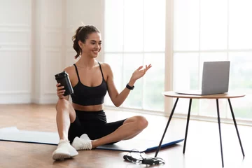 Poster Young woman woman exercising with online trainer using pc © Prostock-studio