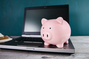 piggy bank on computer laptop