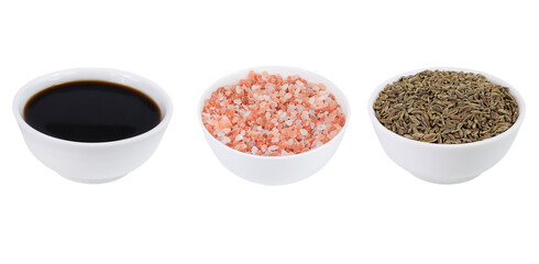 Set of spices and sauce. Cumin, Himalayan salt and soy sauce on an isolated white background.